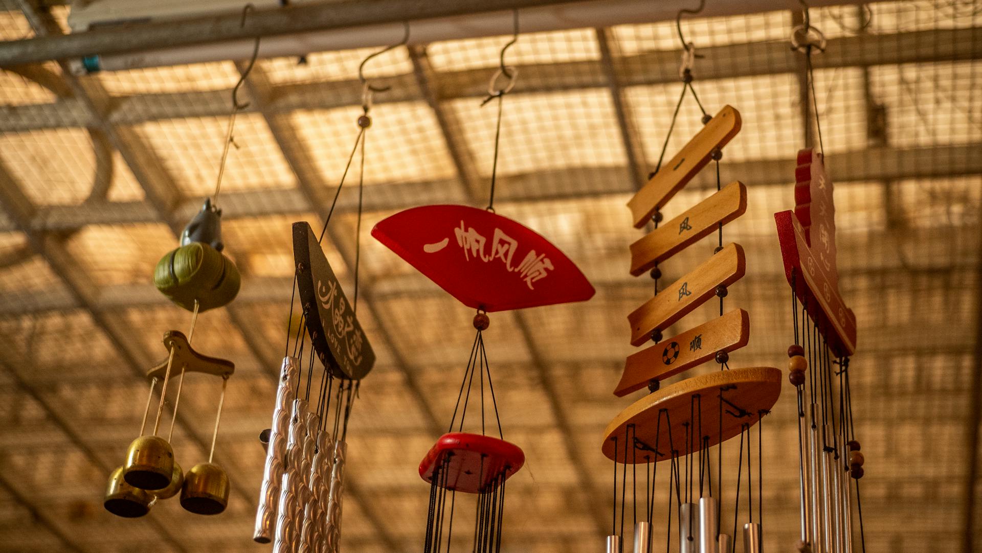 A collection of handcrafted wooden wind chimes hanging indoors, adding traditional charm.