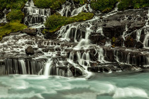 Water Falls on Rocks With Green Trees