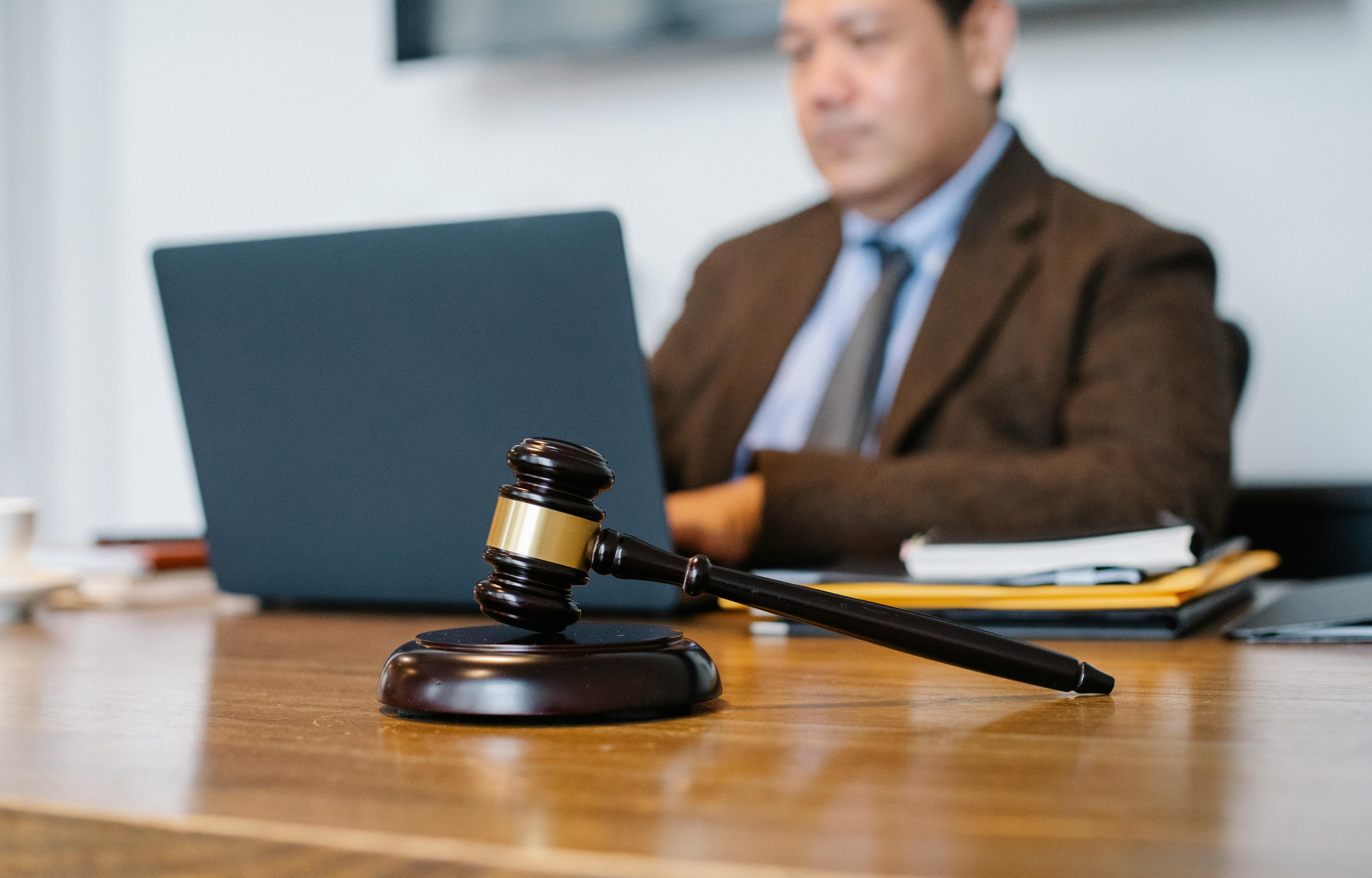 Happy Asian lawyer talking on smartphone in law office \u00b7 Free Stock Photo