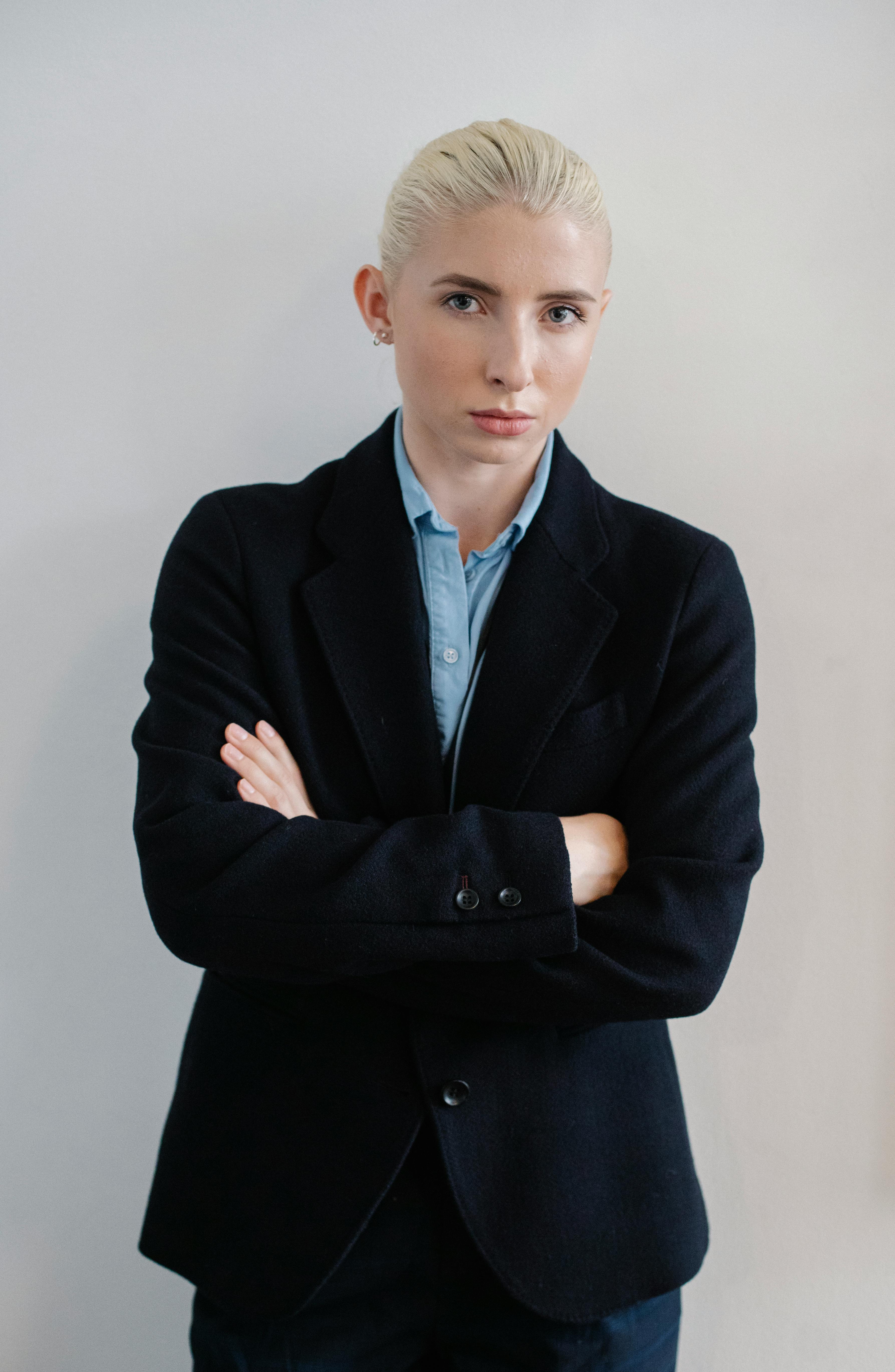 serious businesswoman standing with arms crossed