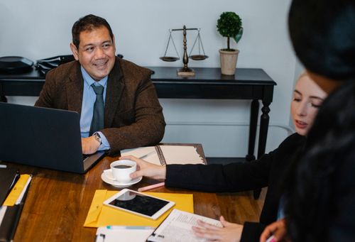 Free Content diverse law office workers wearing formal clothes gathering in conference room and discussing business strategy Stock Photo