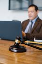 Male lawyer working on laptop in office