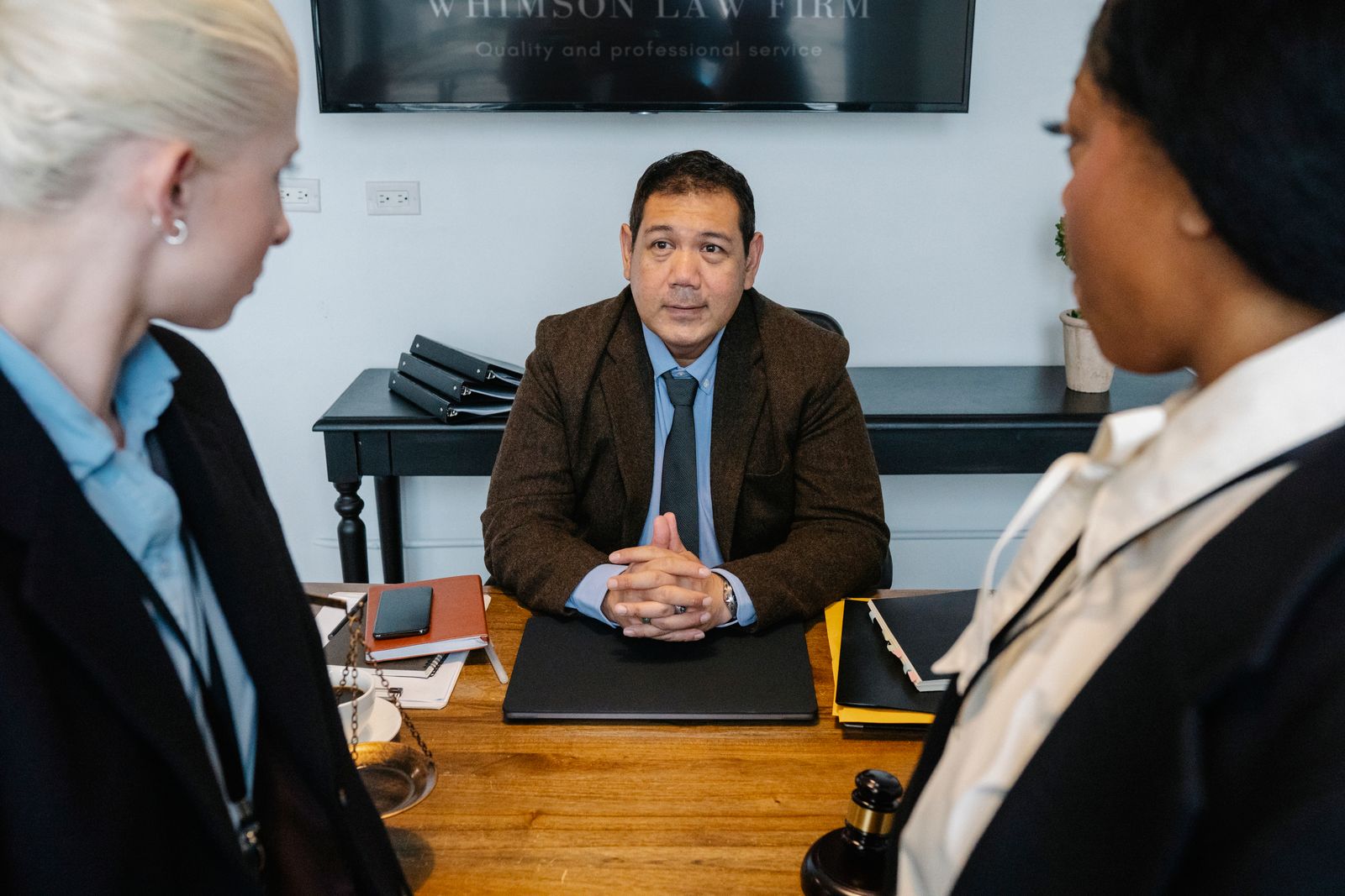 Attorneys in discussion around a table in the firm's office
