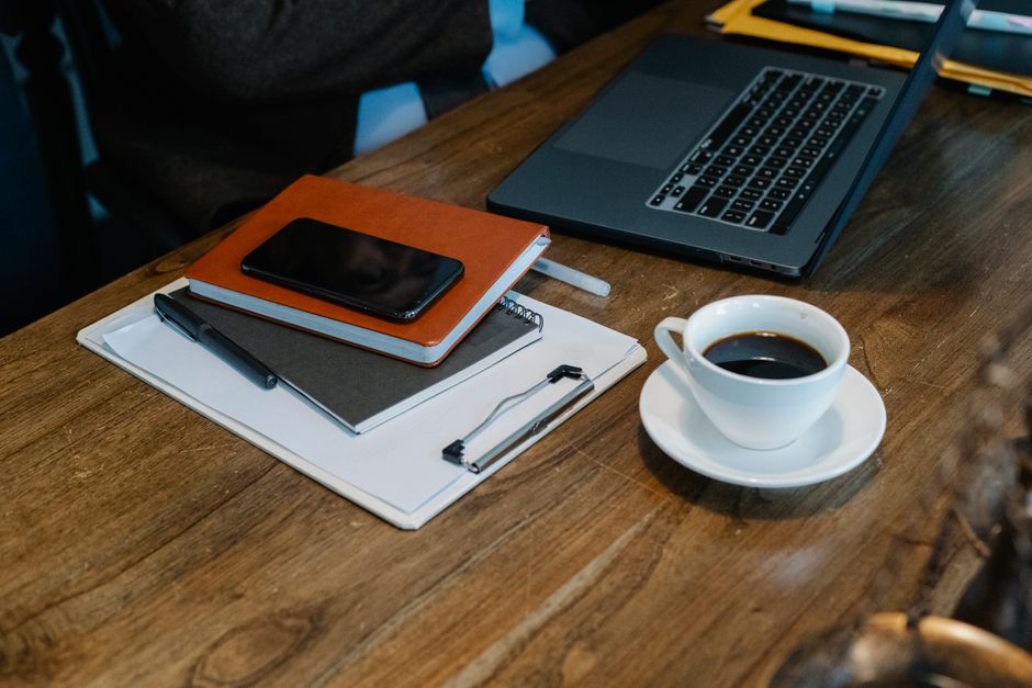 planner beside laptop natural light lifestyle photo 1