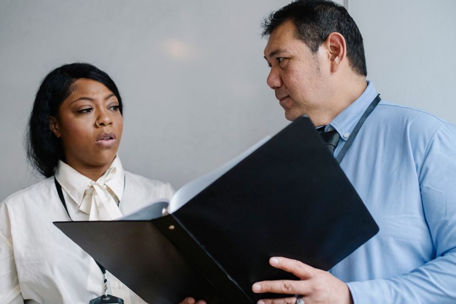 A manager walking an employee through documents