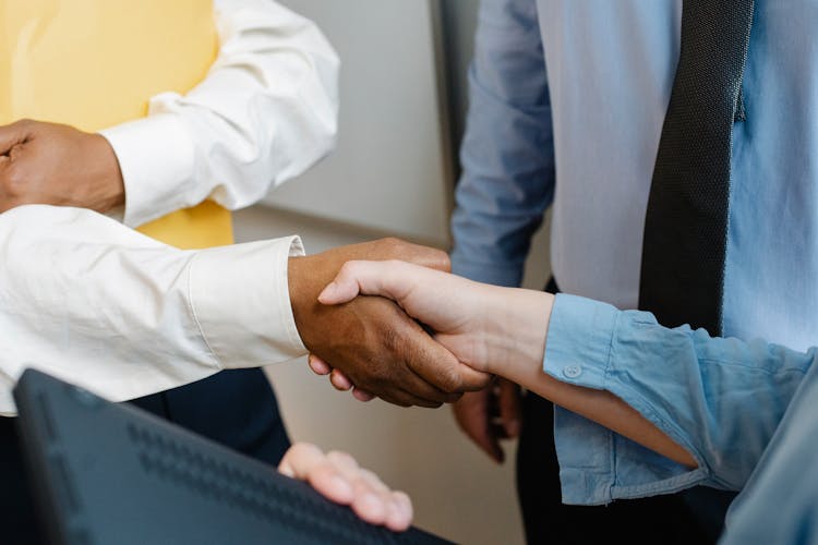 Multiracial Colleagues Shaking Hands At Work