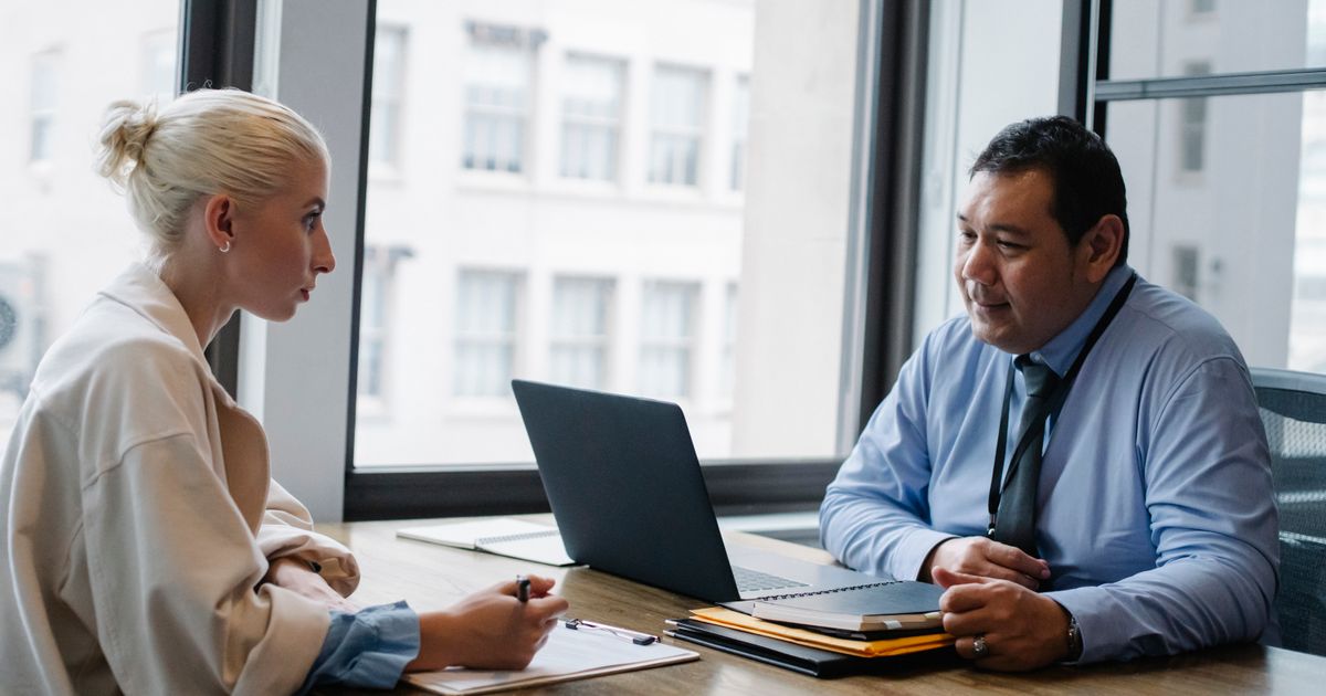 Candidate undergoing a technical interview in an office setting.