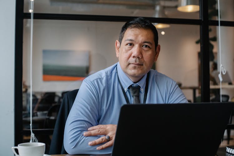 Serious Ethic Businessman Working On Laptop