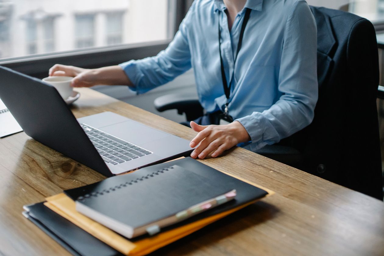 Small business owner batching a month of branded social posts on a laptop with coffee