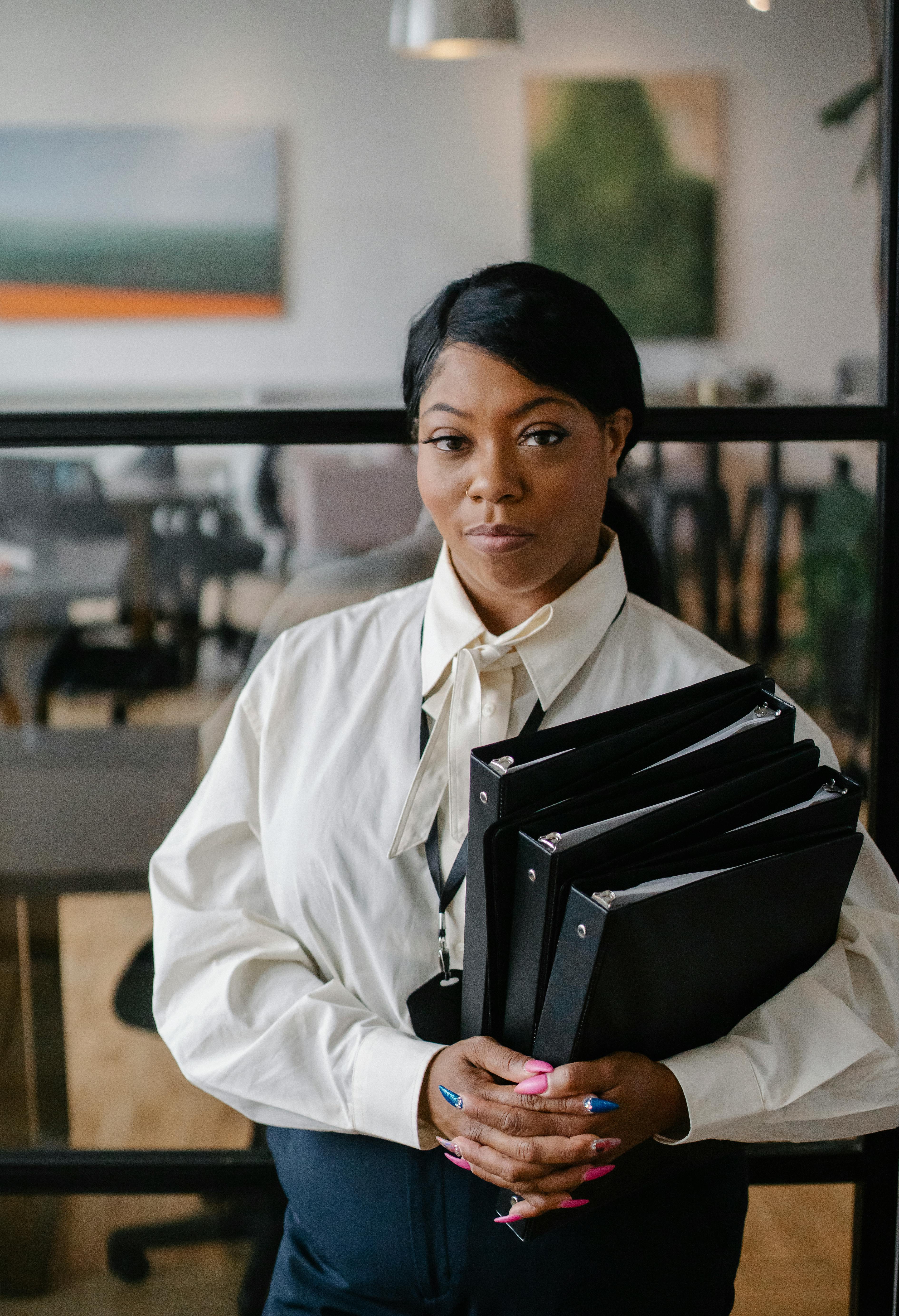 confident female accountant carrying documents