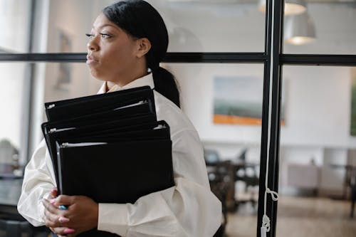 Free Serious Female Accountant Carrying Documents Stock Photo