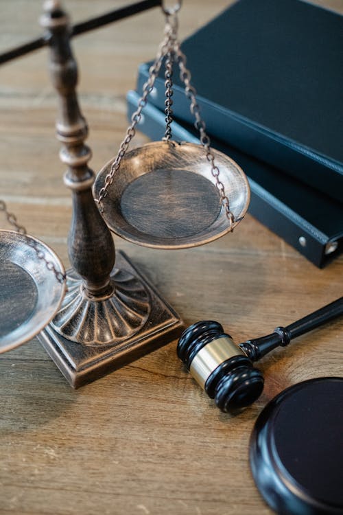 Free From above of judicial symbols consisting of Scales of Justice and small judge hammer with curly handle Stock Photo