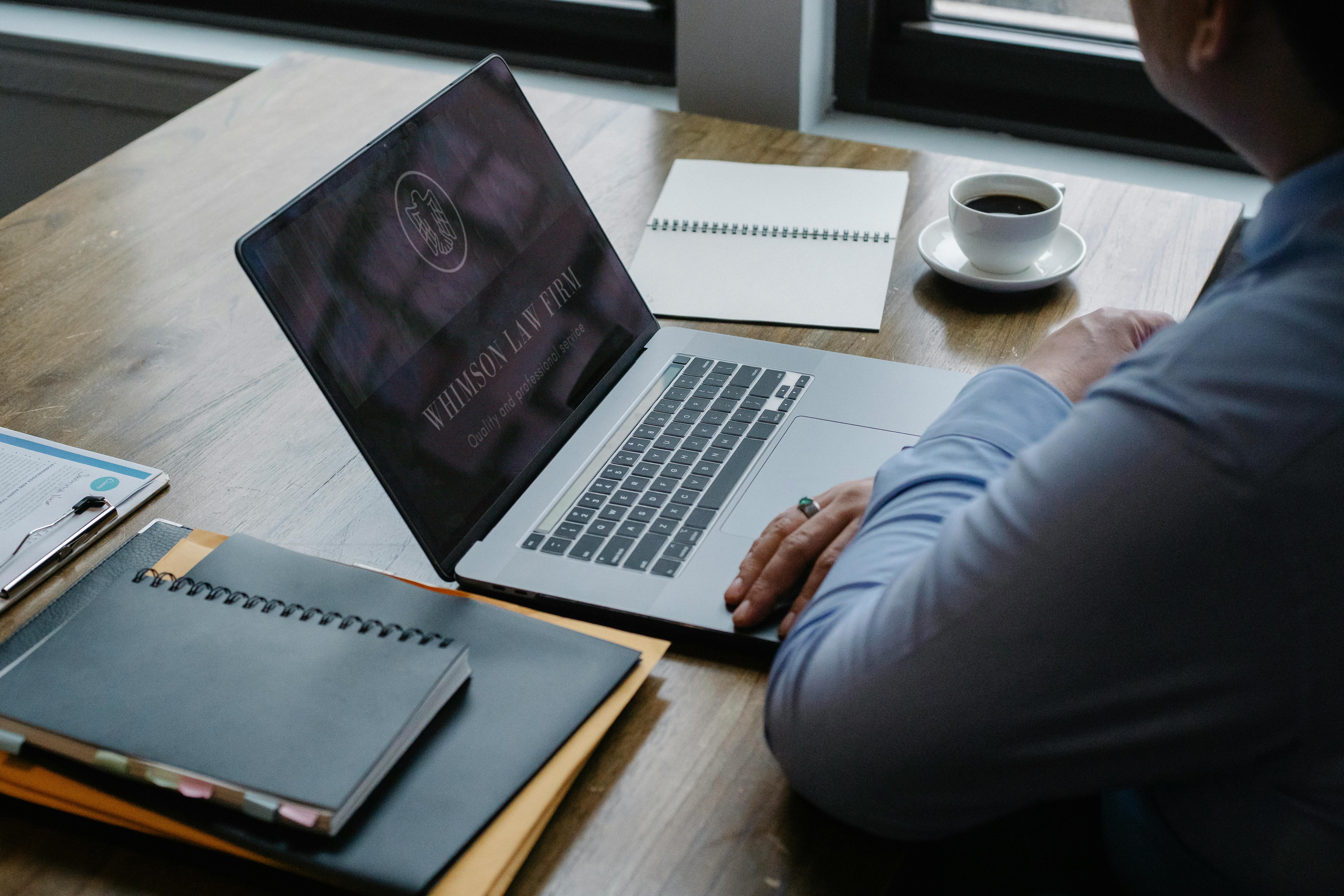 male entrepreneur working at laptop in workplace