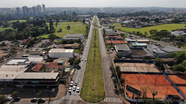 Aerial view of Tucano, Brazil showing a road, buildings, and greenery, captured by drone.