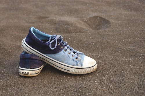 Close-Up Shot of Blue Sneakers on the Sand