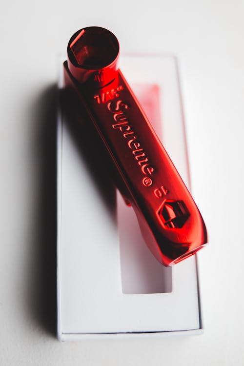 Stylish red skate key pipe placed on gift box