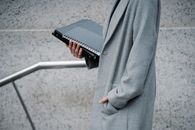 Woman standing with documents on stairs