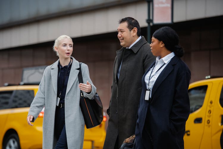 Cheerful Diverse Businesspeople Walking Together On Crosswalk