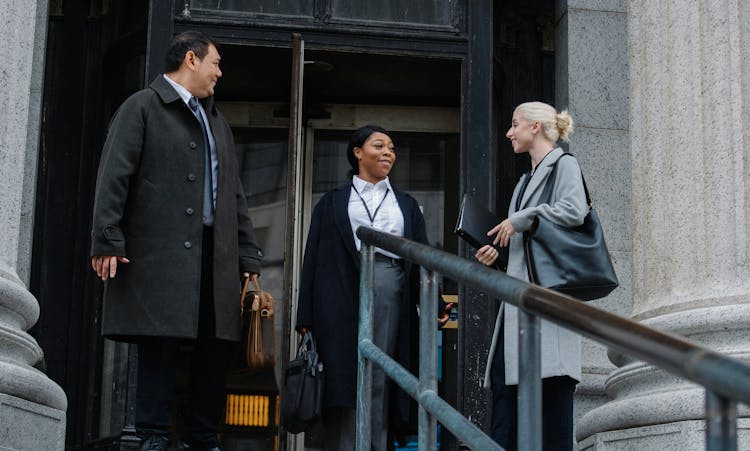 Multiracial Coworkers Chatting Near Building After Work