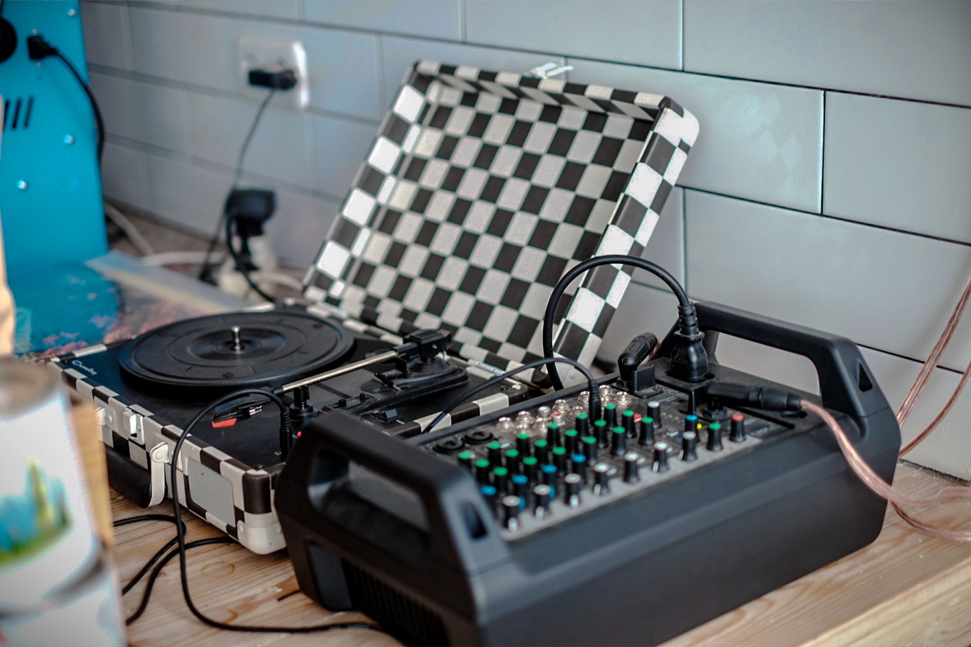 Professional mixer and turntable setup in a modern indoor setting for music production.