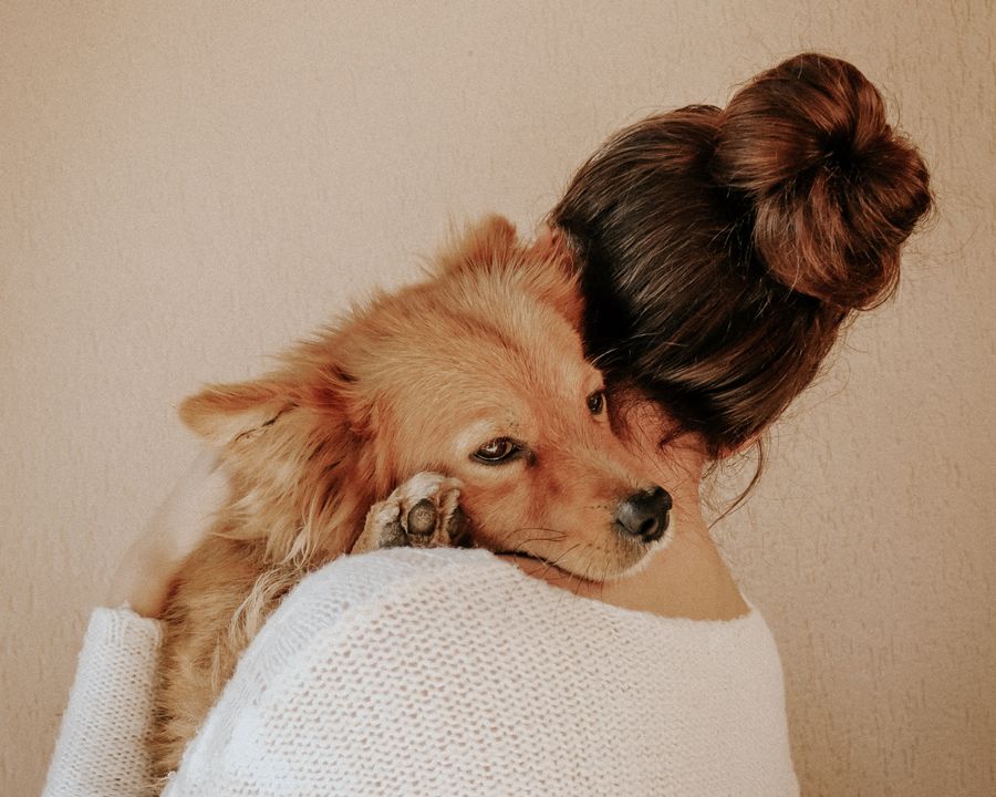 Woman hugging her dog