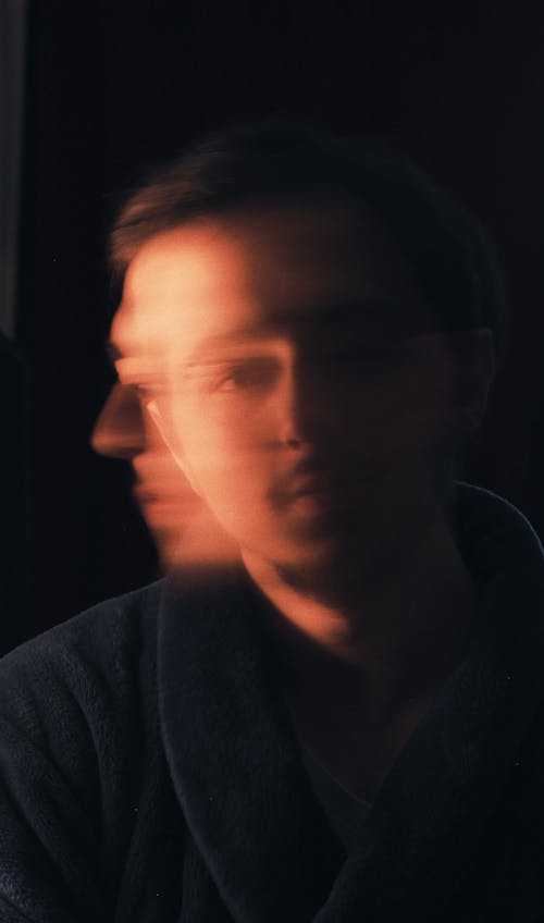 Young bearded man against dark background