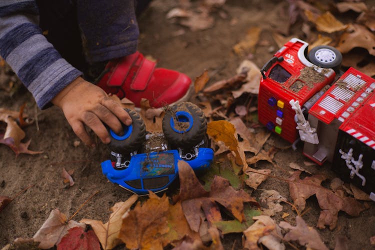 Crop Kid Playing With Toy Car