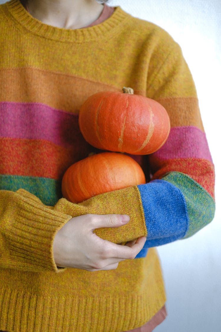 Woman Holding Two Small Pumpkins 