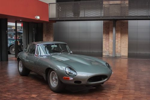 Free Classic Jaguar E-Type sports car exhibited indoors, showcasing luxury and vintage design. Stock Photo