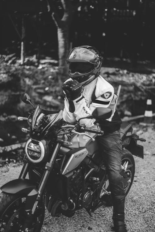 Grayscale Photo of Person Riding A Motorcycle