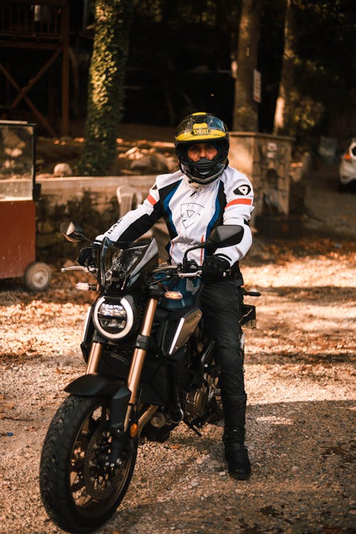 Man Wearing a Helmet Riding a Motorcycle