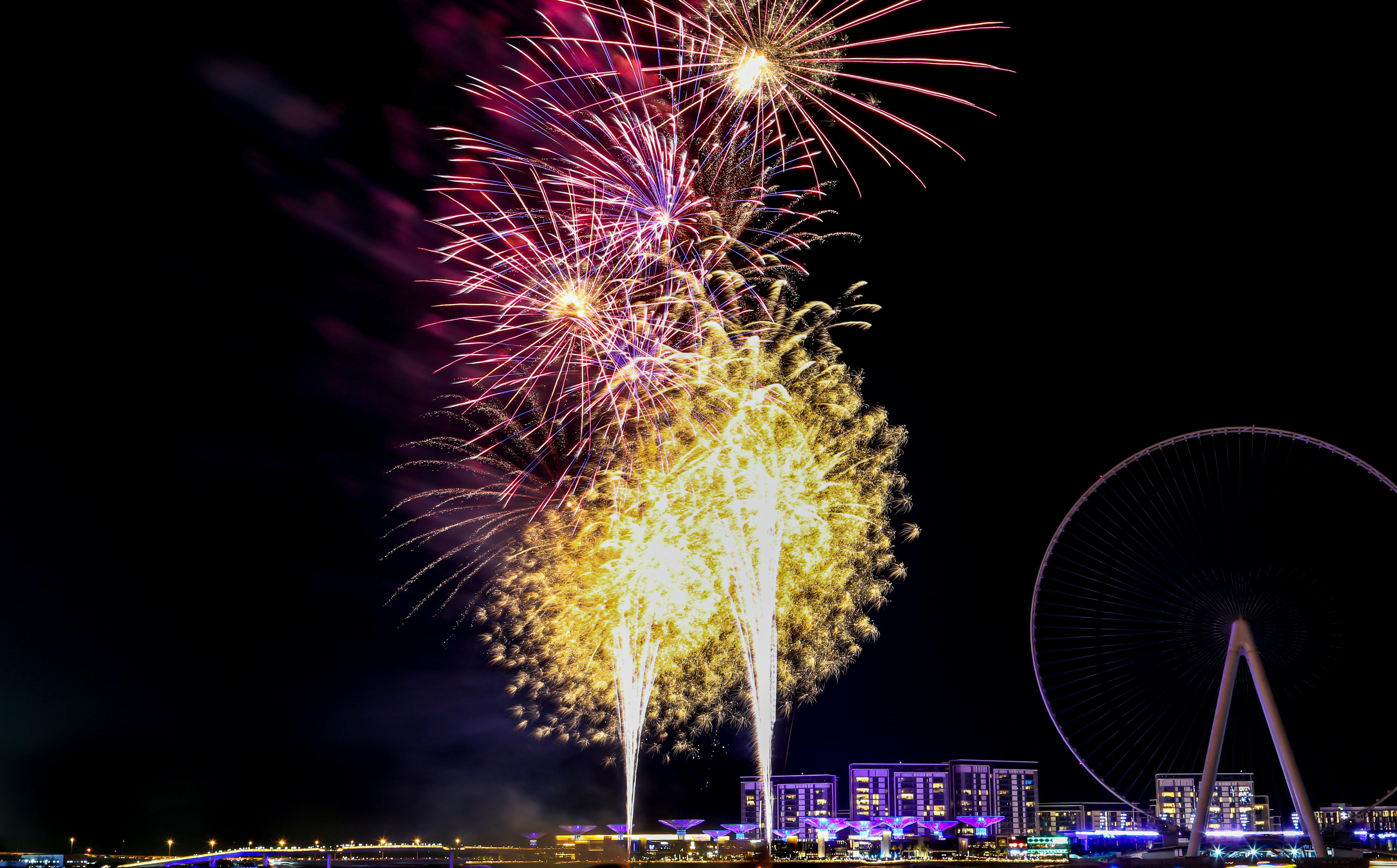 Vibrant fireworks over Dubai's skyline during a winter festival season