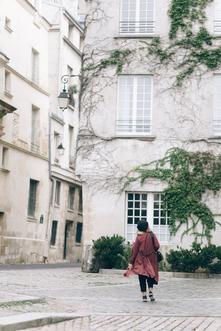 Back View Of A Person Walking Outside The Building