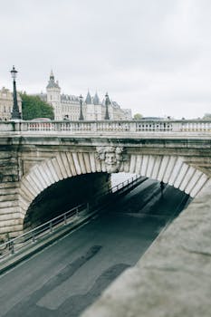 Explore the historic Pont Neuf bridge in Paris with its intricate stone carvings and iconic city backdrop.
