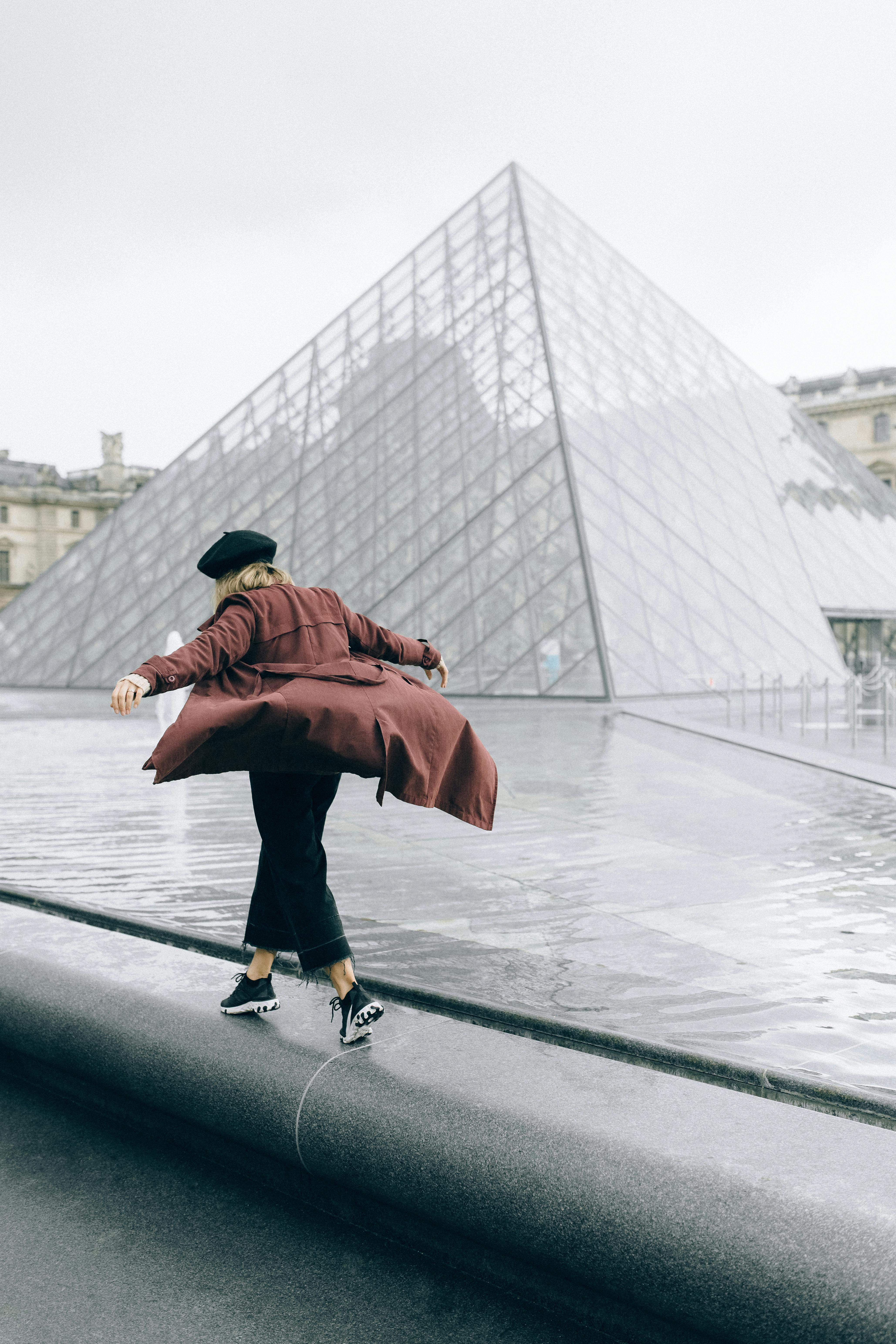 woman walking beside the water fountain