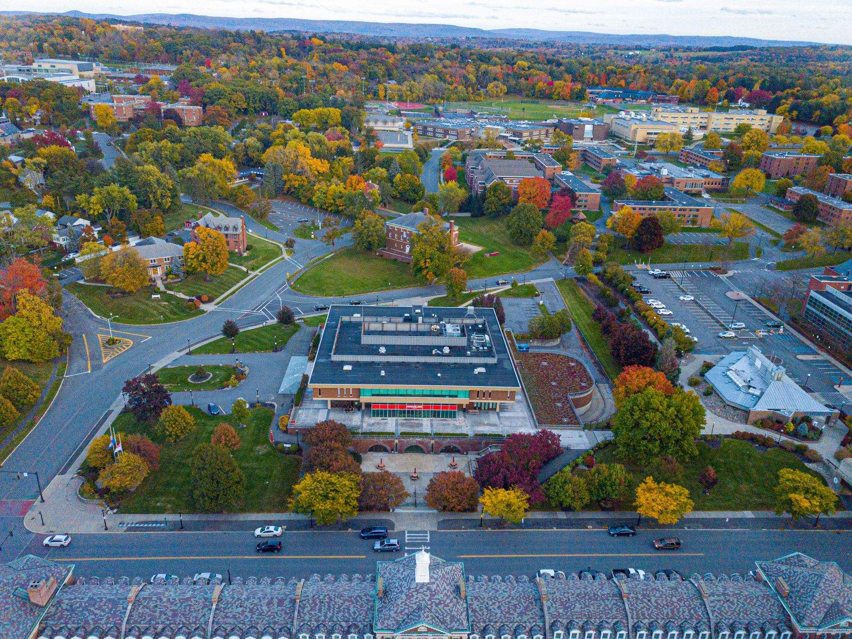 Aerial shot of a college campus during autumn with colorful foliage and modern buildings.