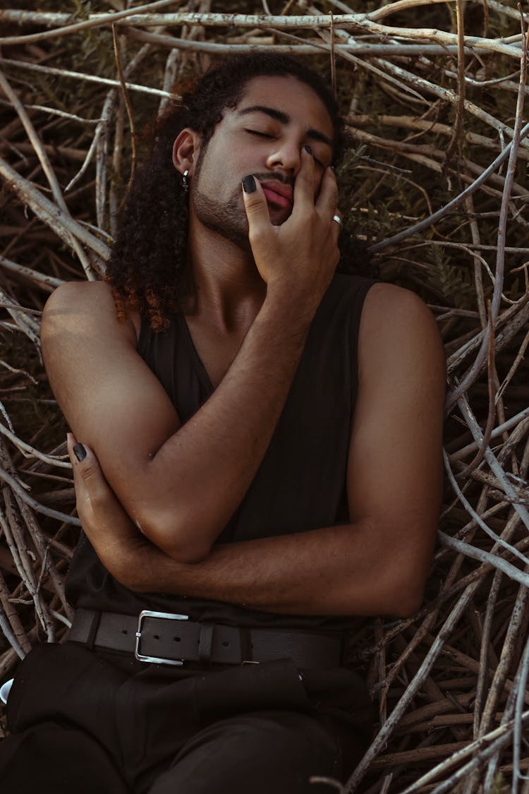 Stylish Sensual Black Man Resting On Tree Twigs