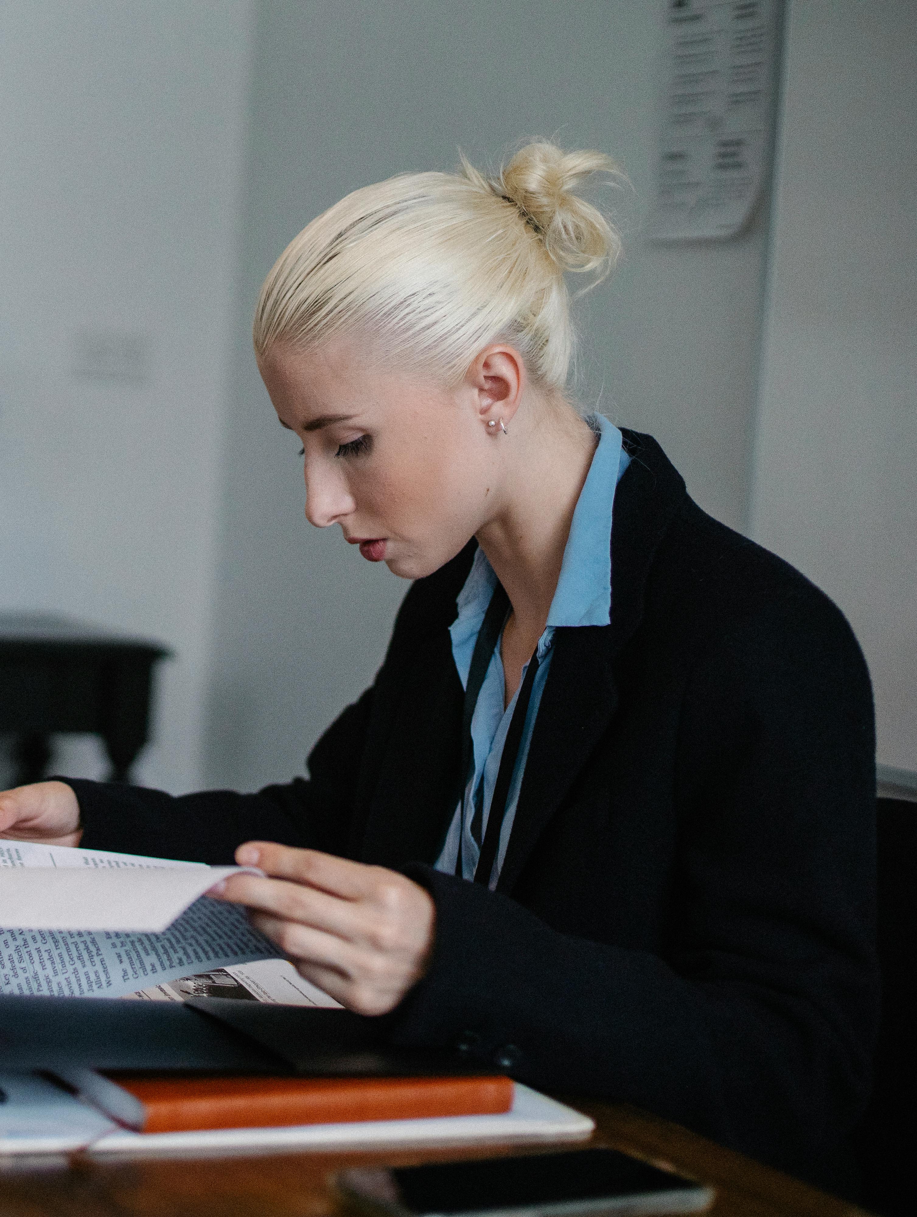 content serious businesswoman reading important report in office