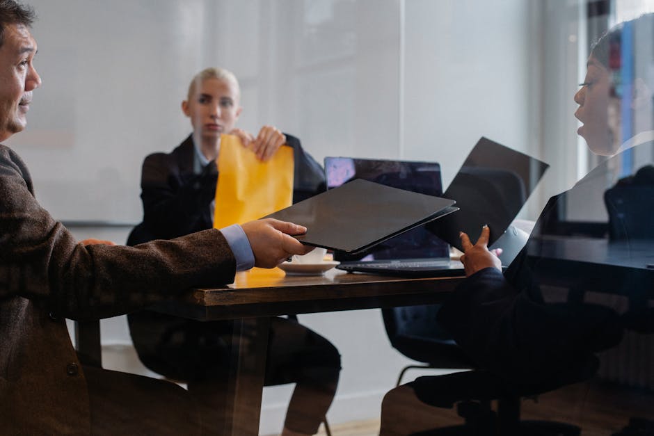 Diverse businesspeople discussing project and documents in office