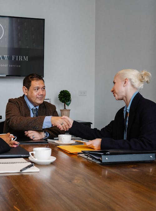 Free Business partners shaking hands in office Stock Photo