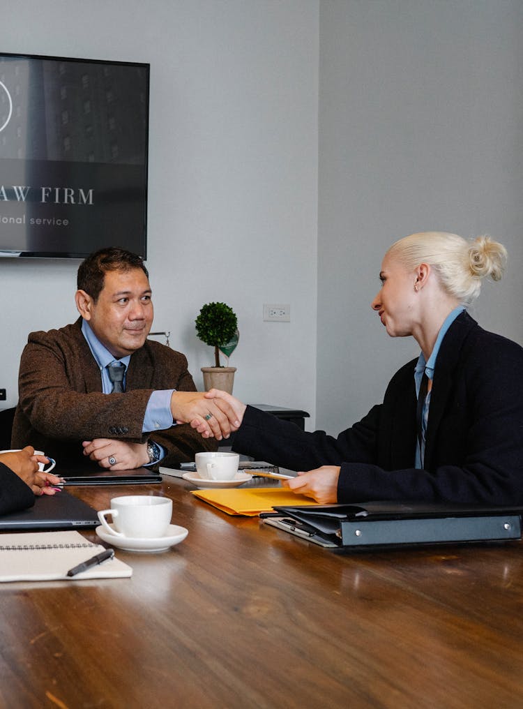 Business Partners Shaking Hands In Office