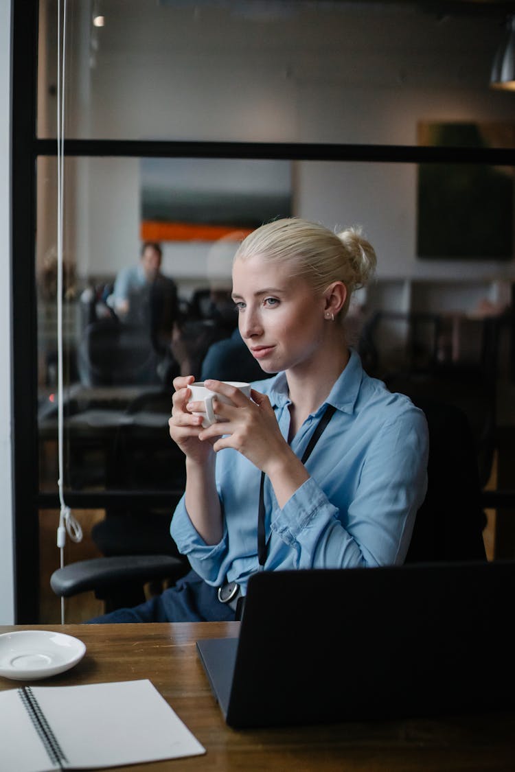 Cheerful Woman With Coffee In Office