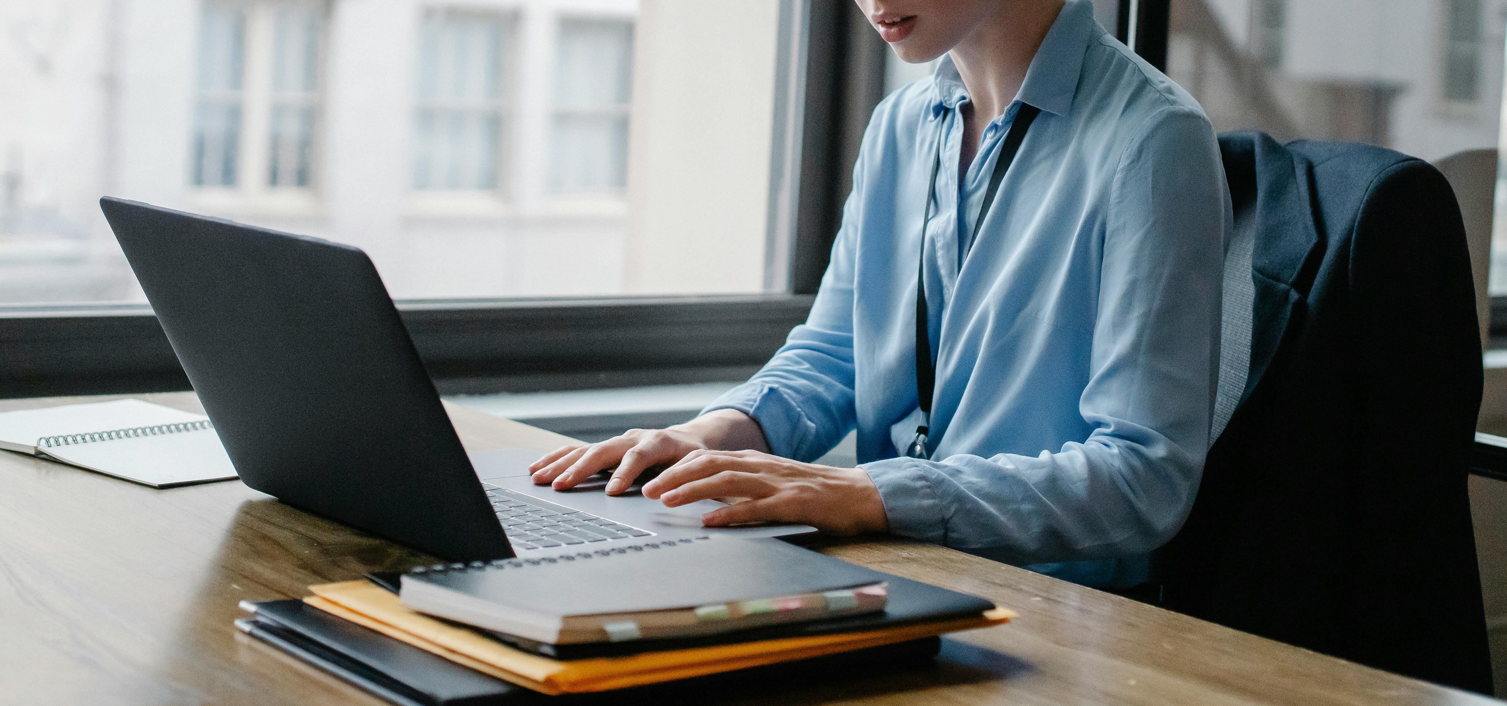 A person using a laptop on a table