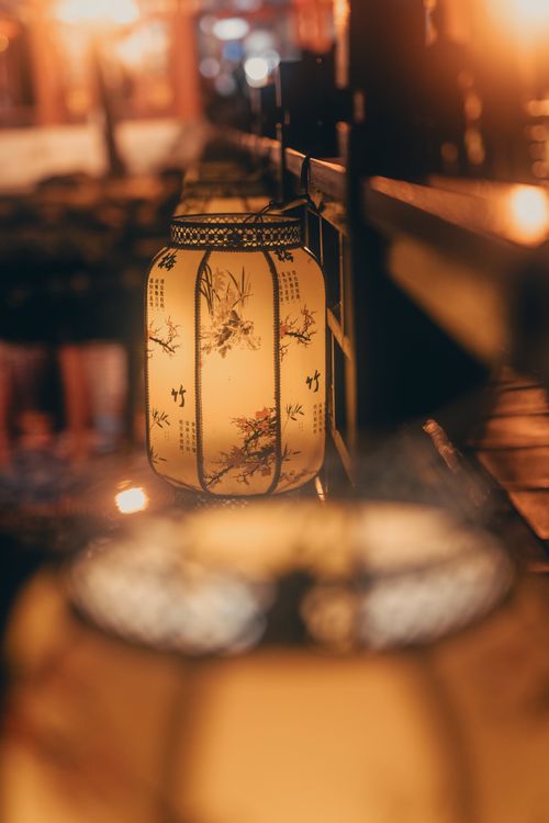 Free Artistic shot of illuminated traditional lanterns lighting a street in Beijing, China. Stock Photo