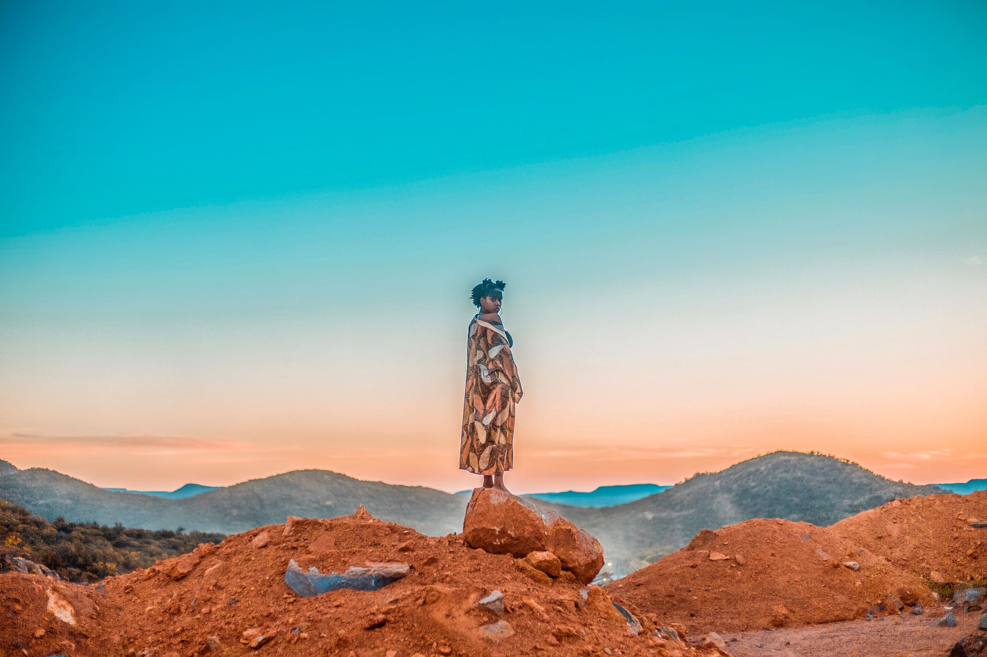 An African woman with a suitcase in a reflective travel moment