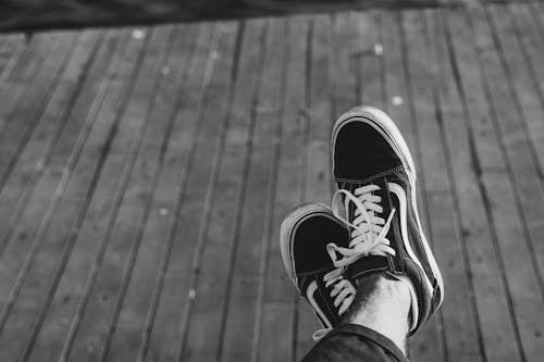 Monochrome Photo of a Person's Shoes