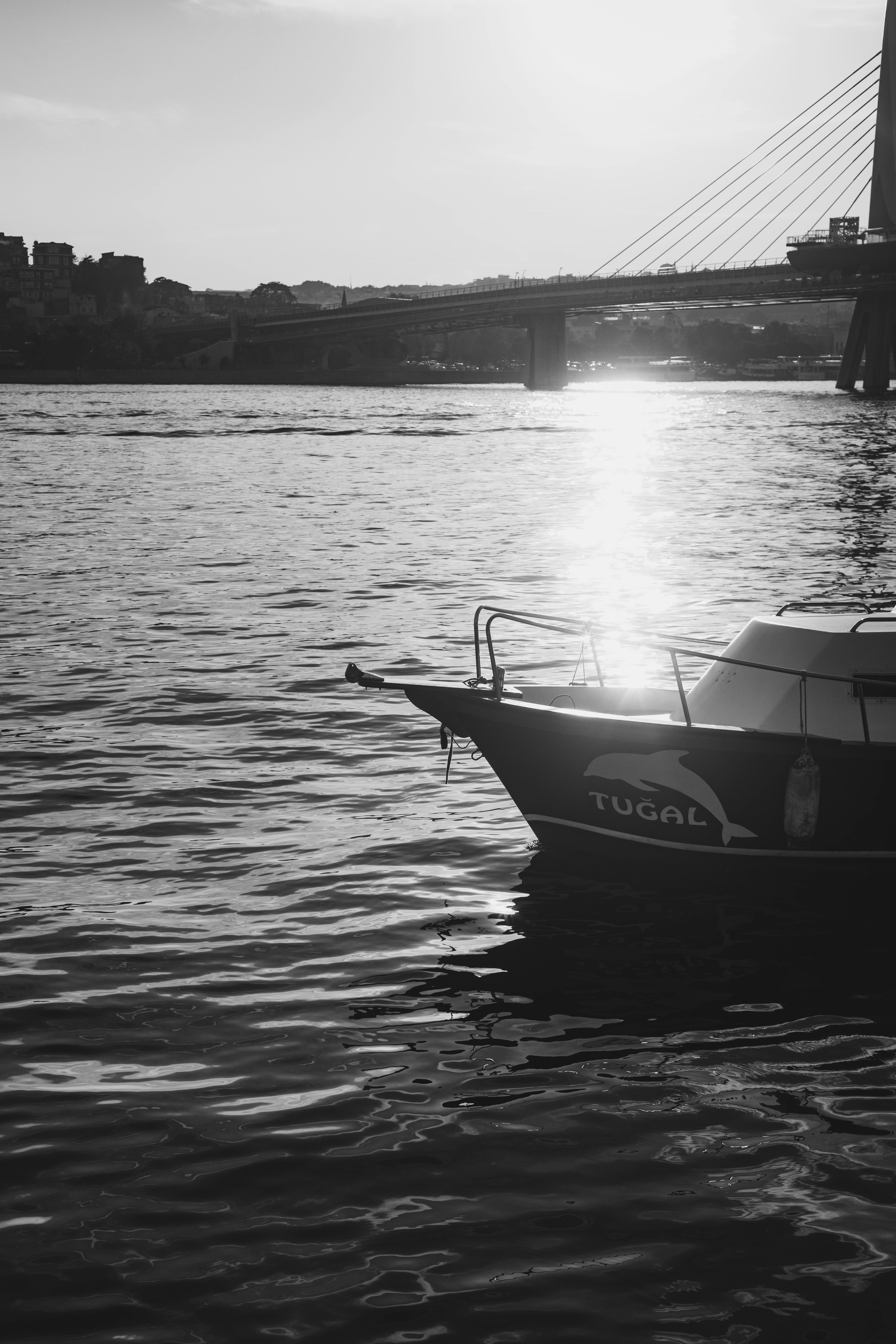 boat moored in a harbor and the golden horn metro bridge in istanbul turkey
