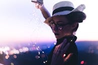Selective Focus Photography of Woman Holding String Lights