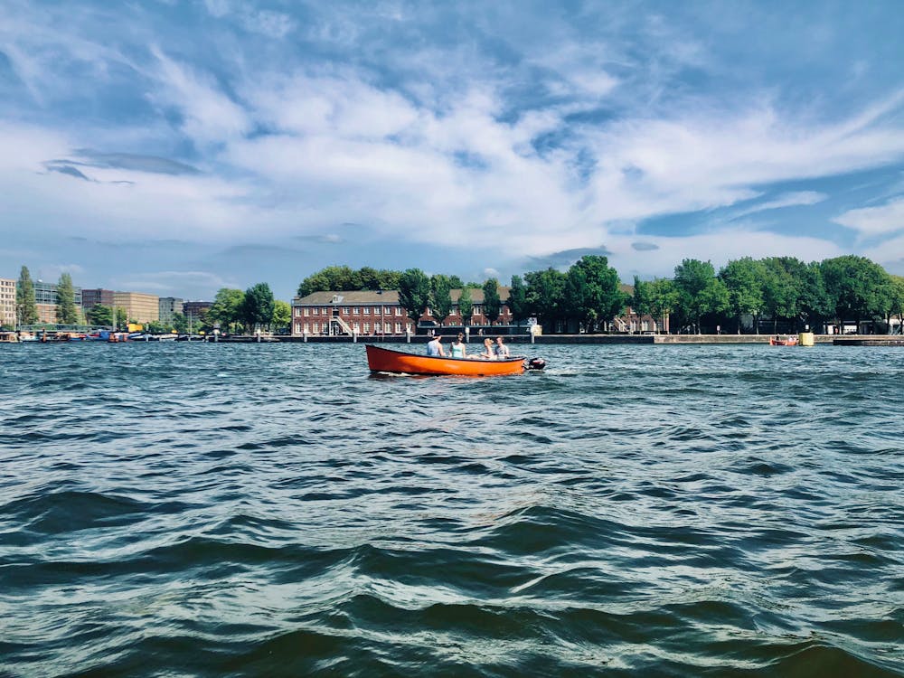 Orange Boat on Body of Water