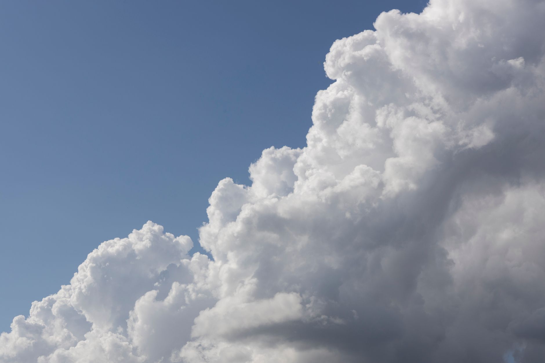 A stunning view of cumulus clouds against a clear blue sky, showcasing natural beauty.